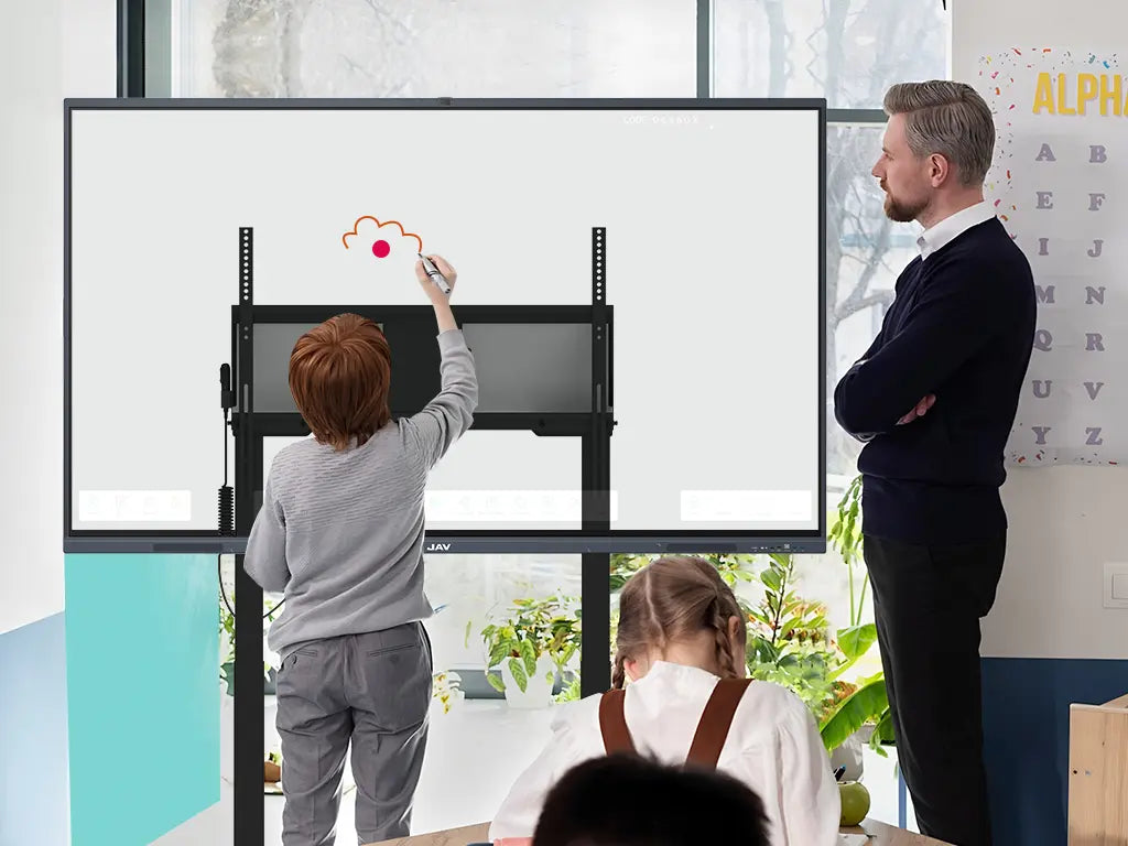 A teacher and young boy interact joyfully with a 98-inch smart board on a motorized lift stand, showcasing child-friendly classroom use.