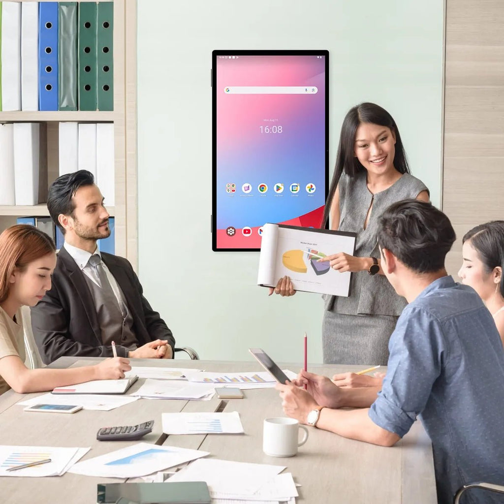 Meeting in progress with the JAV 25S Pro smart digital calendar mounted on the wall.