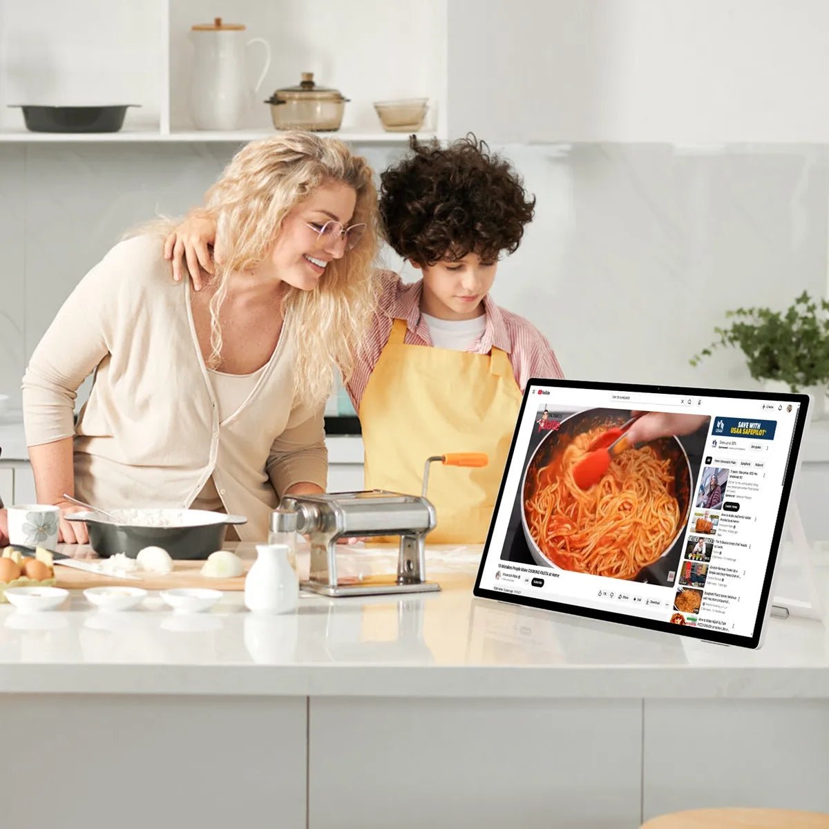 Image of a mother and her son learning to make spaghetti by watching a video on the JAV 25S Pro smart digital calendar.