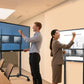 A 1.9m man and 1.5m woman comfortably use the same 98" electric lift stand at different heights, showing flexible adjustment for all heights.