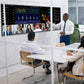 Team using a JAV H15 interactive display for a presentation in a hybrid meeting, with one person standing and pointing at data and video participants on screen.