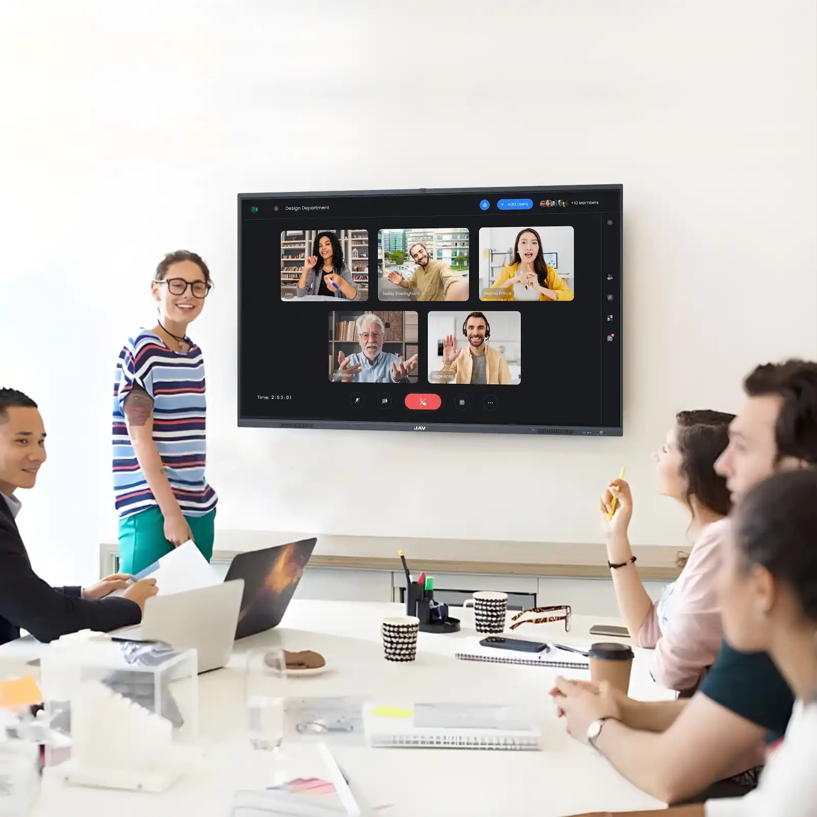 JAV interactive display showing a video conference gallery view connects remote and in-person teams during a hybrid meeting.