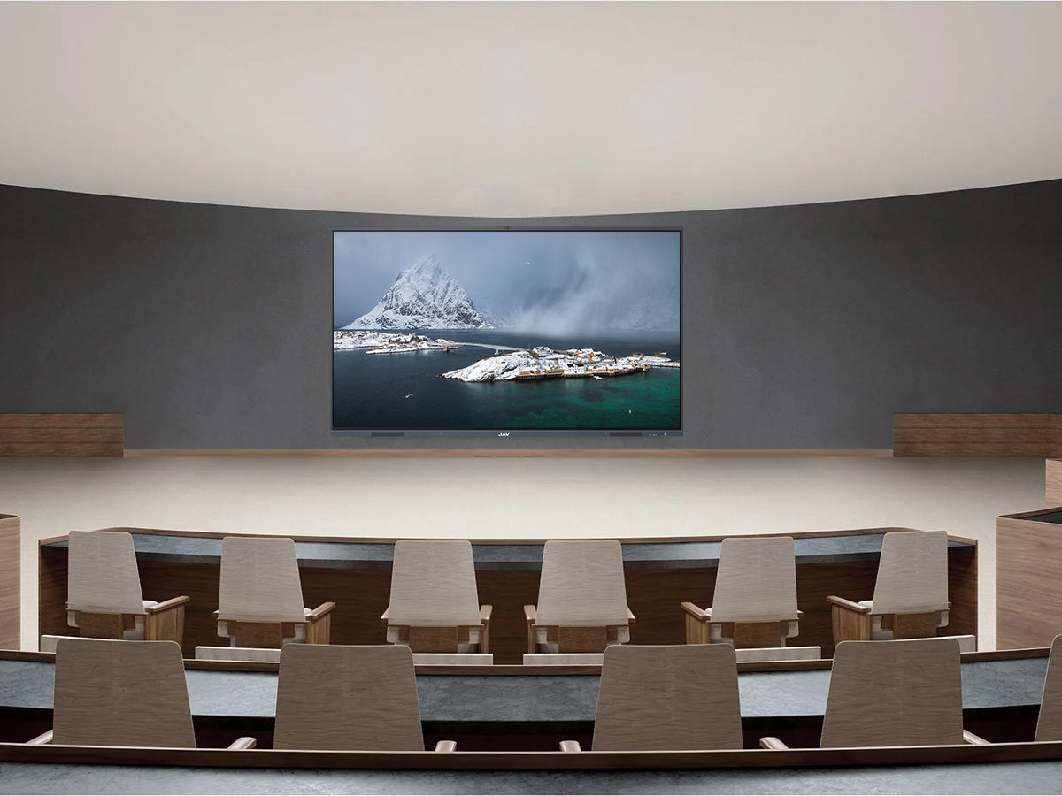 Wall-mounted large-format JAV interactive display showing a scenic image in an empty auditorium or lecture hall setting.