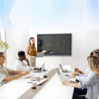 JAV H10S Pro interactive flat panel showing stock charts or business data as part of a presentation to colleagues.
